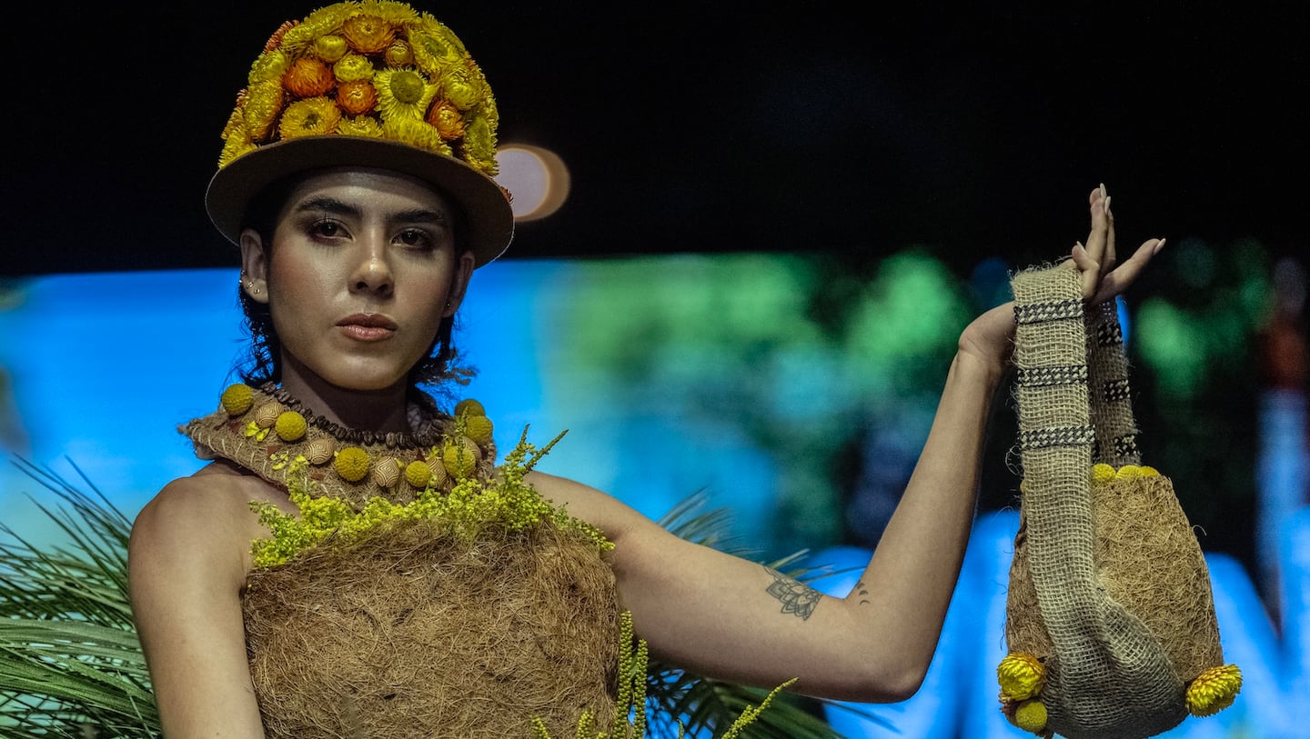 A model presents a creation by Spanish designer Lara Alonso made with organic elements during the UN’s COP 16 biodiversity summit in Cali, Colombia.
