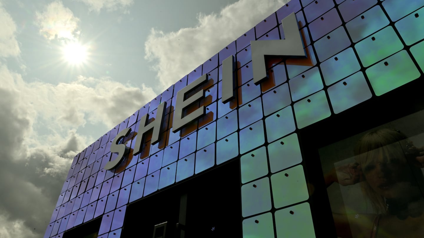 A Shein sign on the outside of a shopping centre.