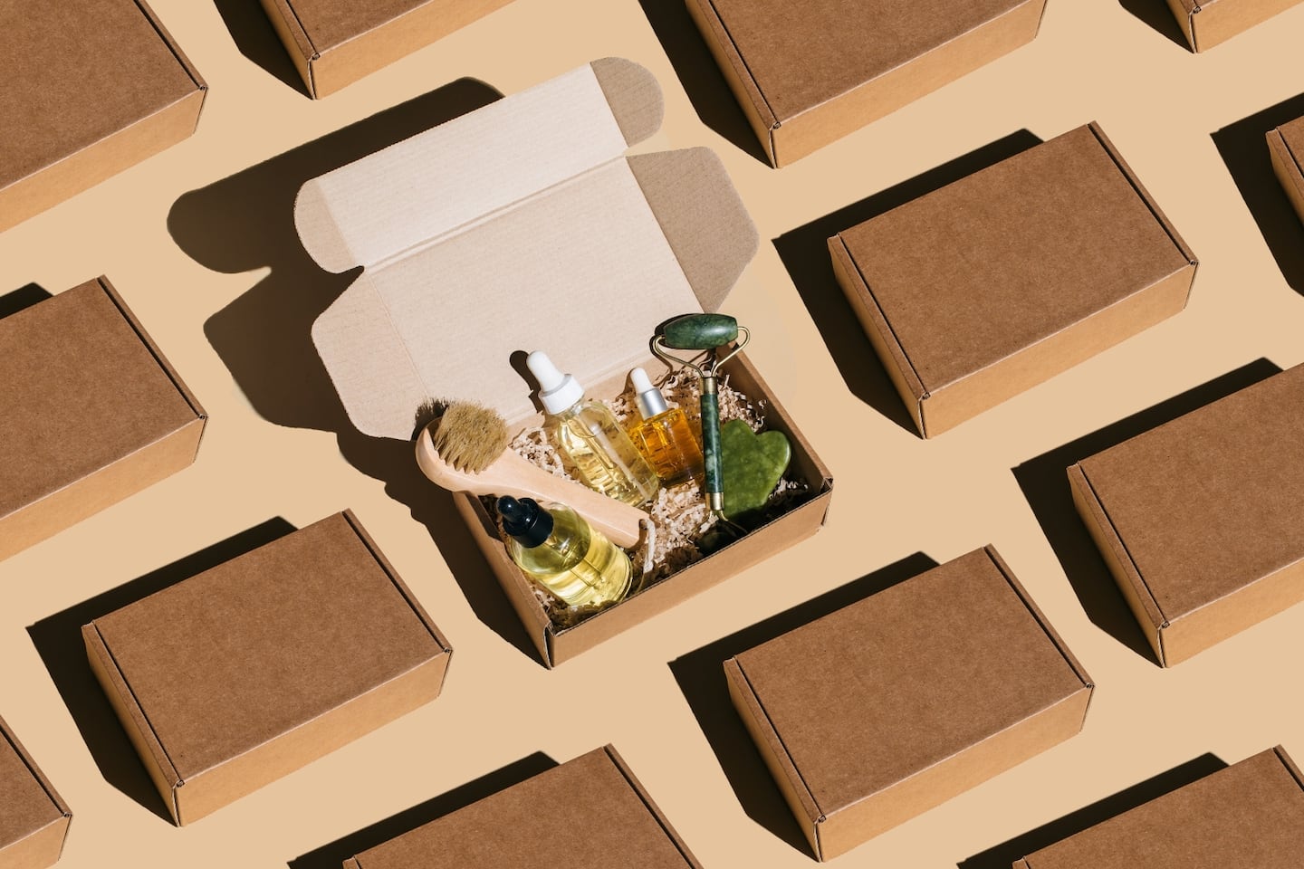 A photo shows a grid of several closed boxes, with one open box in the middle to reveal a haul of beauty products, including face oils and a jade roller.