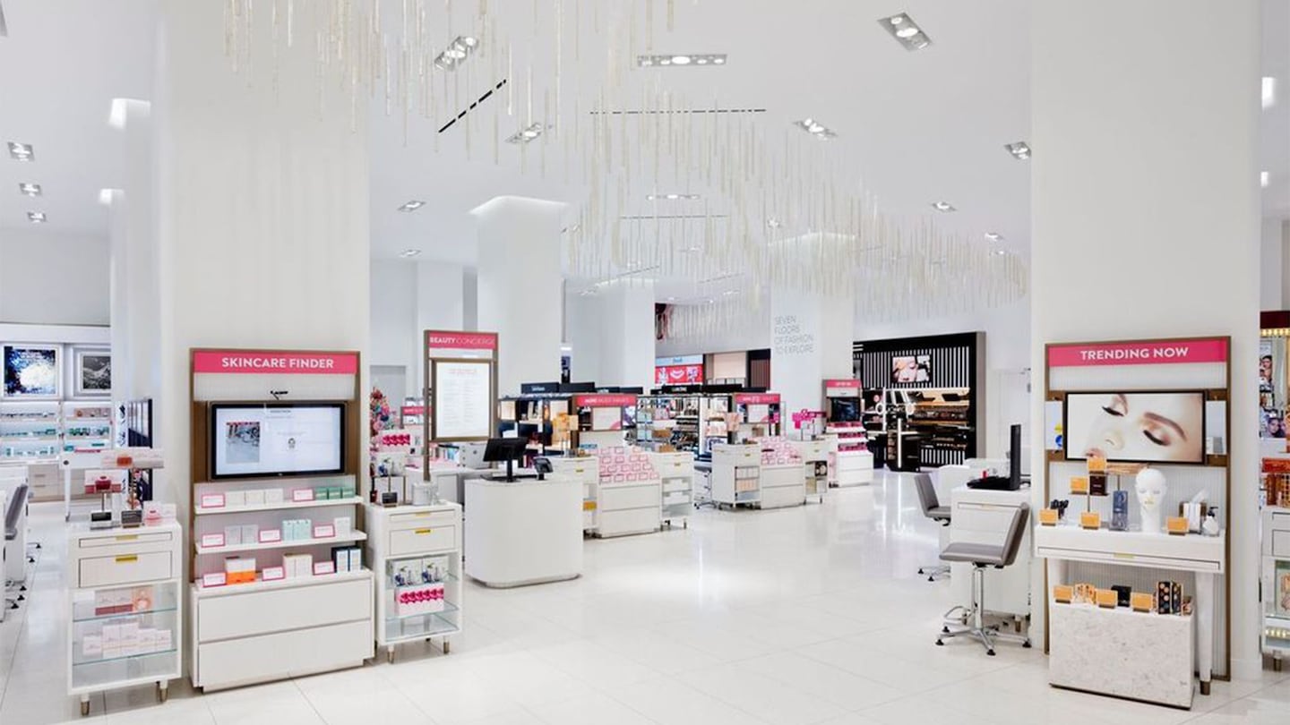 A quiet scene from the Nordstrom 57th Street store beauty floor features snow-white floors, pillars, and ceilings, and glossy white displays. Signs say "Skincare Finder" and "Trending Now."